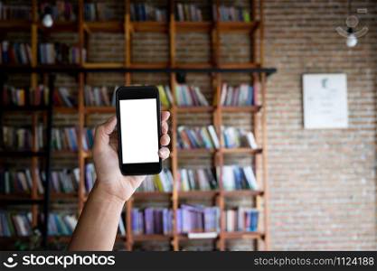 Man holding blank screen of a smartphone at the library.