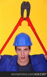 Man holding bolt-cutter over his head
