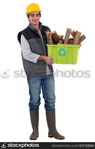 Man holding box of wood to be recycled