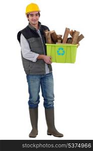 Man holding box of wood to be recycled