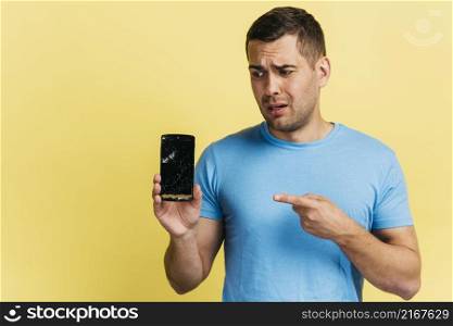 man holding broken phone