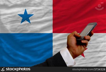 man holding cell phone in front national flag of pakistan symbolizing mobile communication and telecommunication