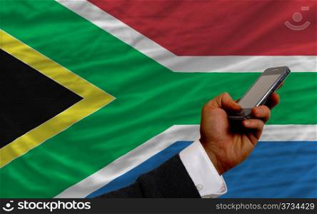 man holding cell phone in front national flag of russia symbolizing mobile communication and telecommunication