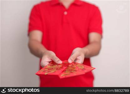 man holding Chinese red envelope with golden rabbit and blessing word, money gift for happy Lunar New Year holiday. Chinese sentence means happiness, healthy, Lucky and Wealthy