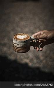 Man holding coffee cup with latte art, Selective focus. Man holding coffee cup with latte ar