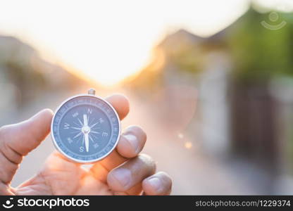 man holding compass on blurred background. for activity lifestyle outdoors freedom or travel tourism and inspiration backpacker alone tourist travel or navigator image.