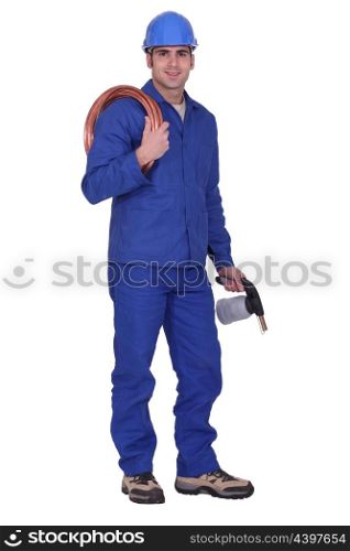 Man holding copper piping and blowtorch