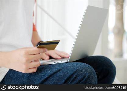 Man holding credit card and using laptop computer to shopping on line, business and technology concept, digital marketing, casual lifestyle
