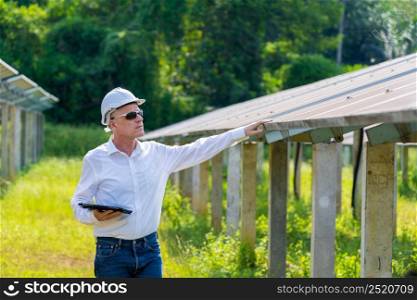 Man holding digital tablet examining generation of solar power plant,Concept of online monitoring of the electric station,Green energy.