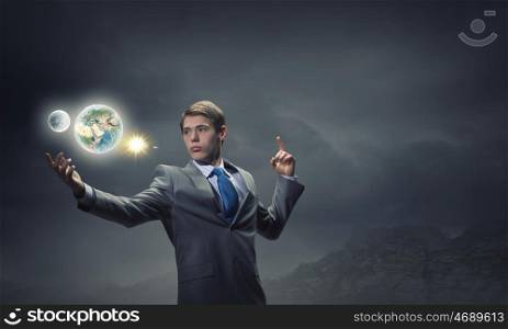 Man holding Earth planet. Young handsome businessman and Earth planet. Elements of this image are furnished by NASA