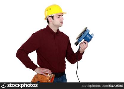 Man holding electric sander