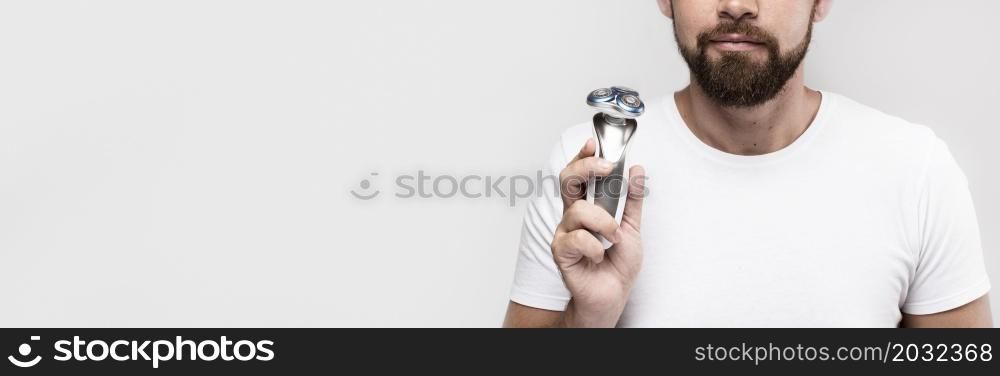 man holding electric shaver with copy space