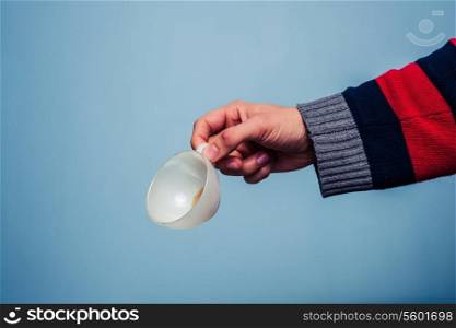 man holding empty cup