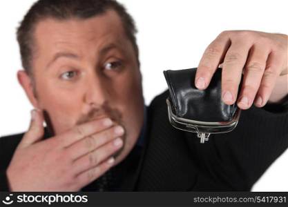 Man holding empty purse