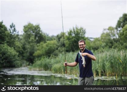man holding fishing rod with fish hook