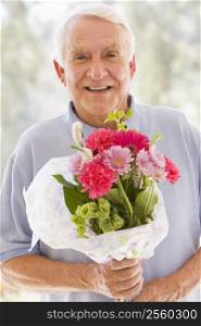 Man holding flowers and smiling