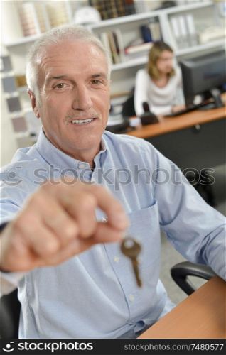 Man holding forward a key