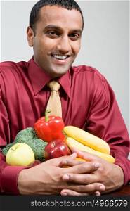 Man holding fruit and vegetables
