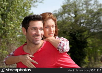 Man holding girlfriend on his back