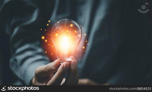 Man holding glowing light bulbs. Inspiration ideas of studying in education with innovative technology and creativity. Success concept of knowledge or cognition inspiration and motivation concept