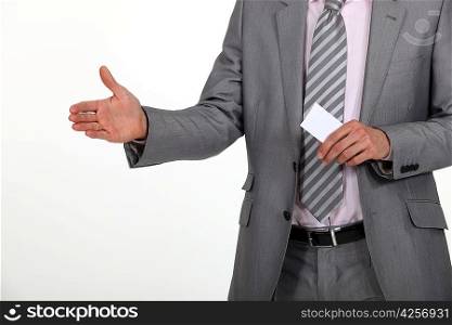 Man holding hand out and carrying business card