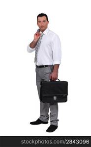 Man holding jacket over shoulder and holding briefcase