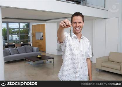 Man holding key in new home, portrait