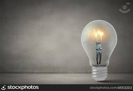 Man holding luminous idea inside light bulb. Creativity man