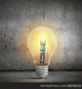 Man holding luminous idea inside light bulb. Creativity man