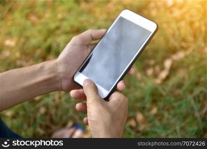 Man holding mobile smart phone using smart application by internet online