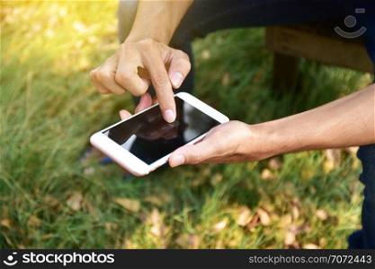 Man holding mobile smart phone using smart application by internet online