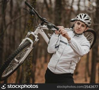 man holding mountain bike