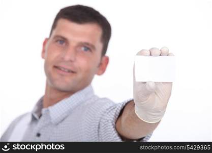 man holding out blank business card