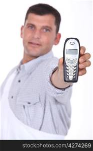 Man holding out mobile telephone