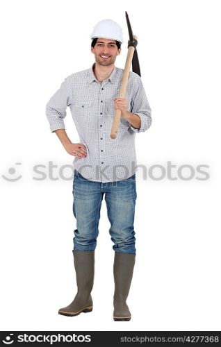 Man holding pick-axe over shoulder