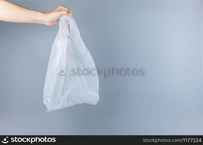 Man holding plastic bag against gray background with Copy space for text. Environmental Protection, Zero waste, Reusable, Say No Plastic, World Environment day and Earth day concept