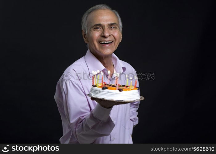 Man holding plate of cake