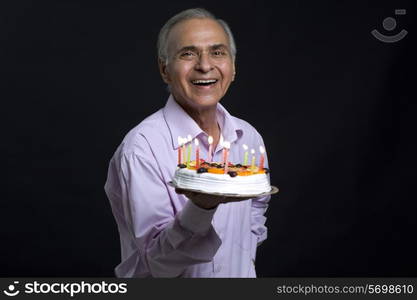 Man holding plate of cake