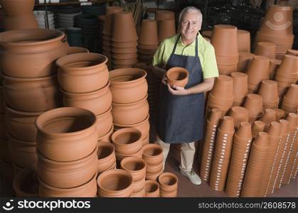 Man holding pot in a garden center