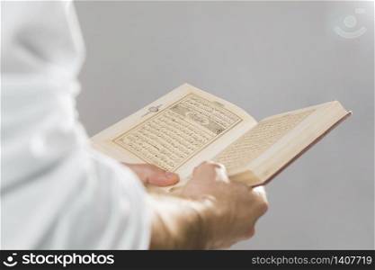 man holding quran book