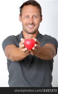 Man holding red heart in his hands