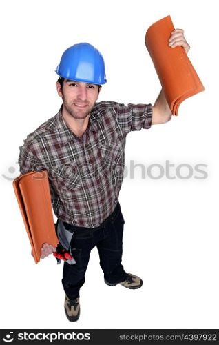Man holding roof tiles