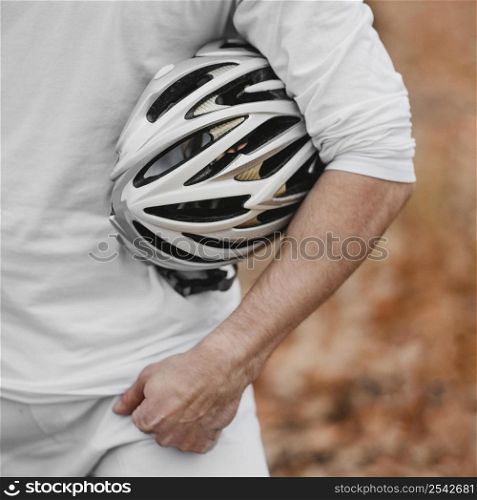 man holding safety helmet biking