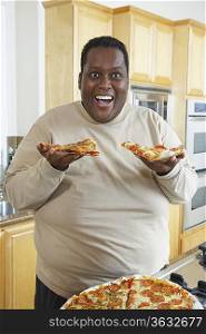 Man holding slices of pizza and laughing