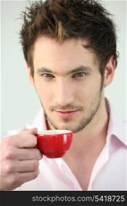 Man holding small cup of coffee
