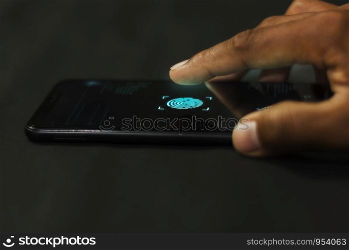 Man holding smartphone with fingerprint scanners to system connect to the database via security system high technology.