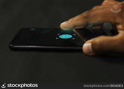 Man holding smartphone with fingerprint scanners to system connect to the database via security system high technology.