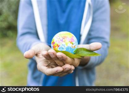 man holding sphere palm hand with leaf. High resolution photo. man holding sphere palm hand with leaf. High quality photo