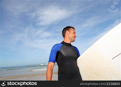 Man holding surfboard at the beach