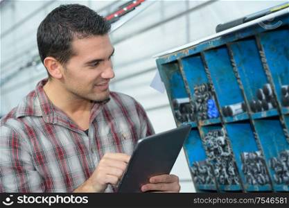 man holding tablet in factory